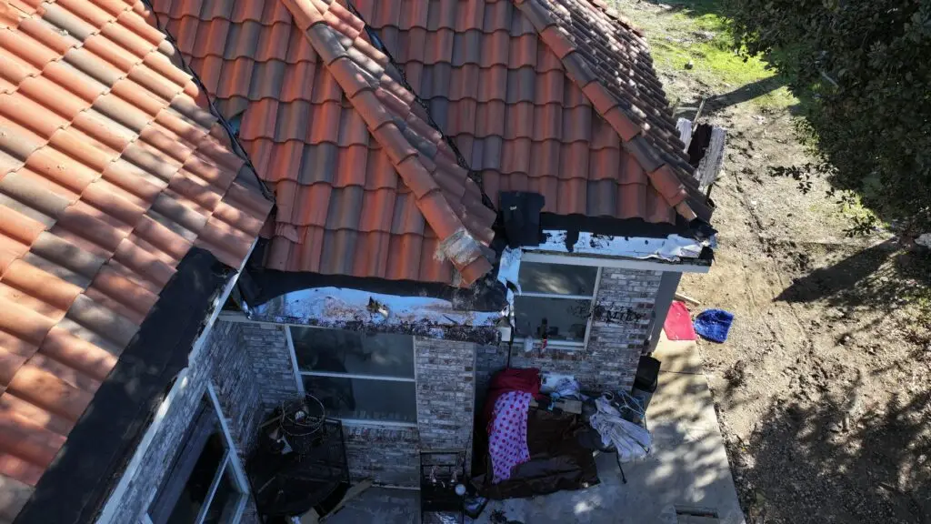 Damaged tile roof edge before repairs in Dallas–Fort Worth home