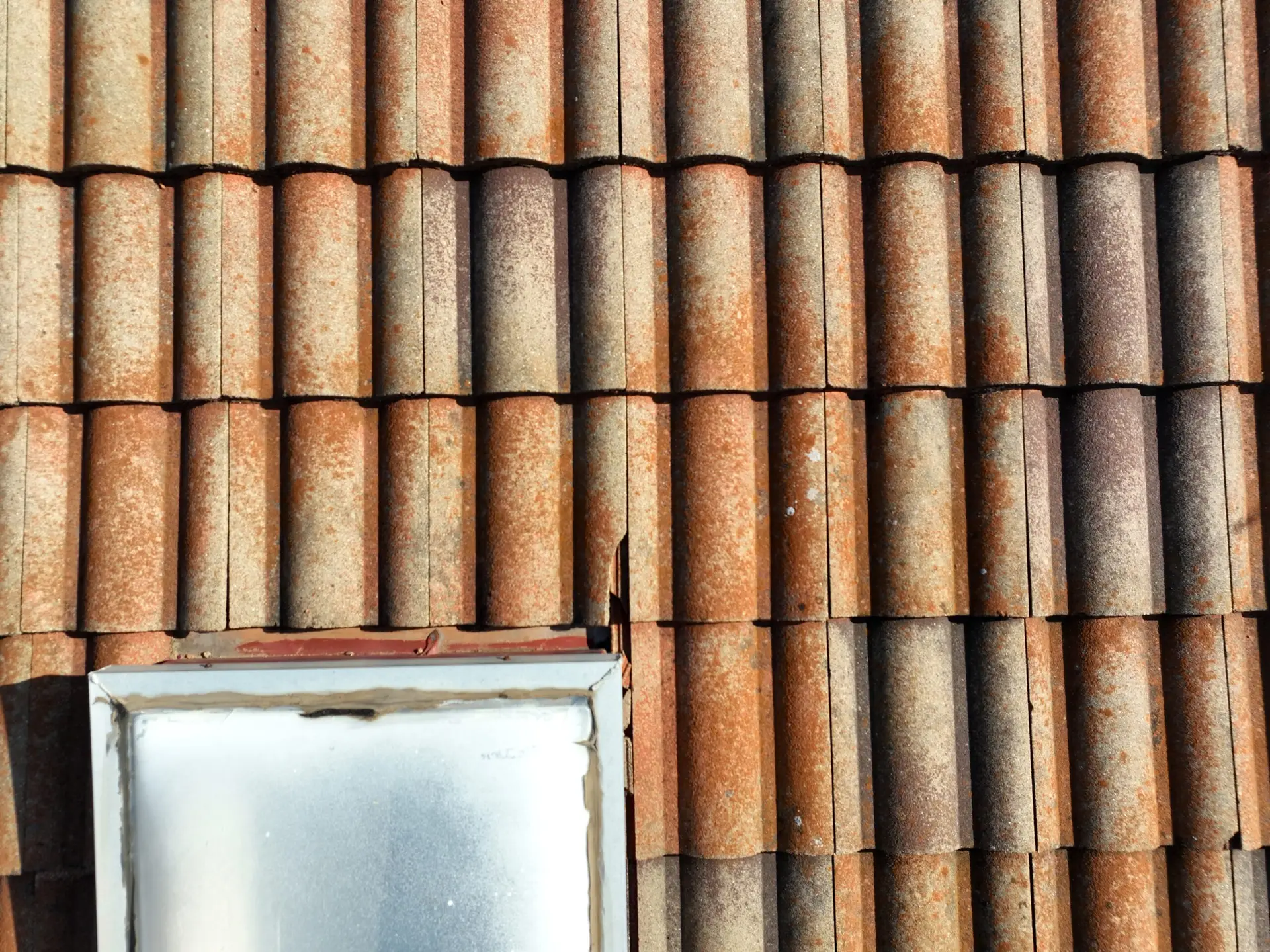 Cracked tile roof in Dallas–Fort Worth showing signs of water damage