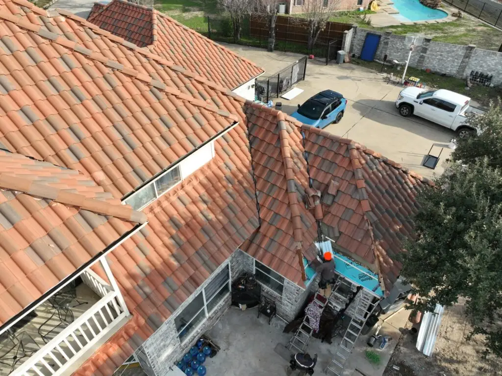Roof tiles being reset after edge repair by Shepherd Tile Roofing