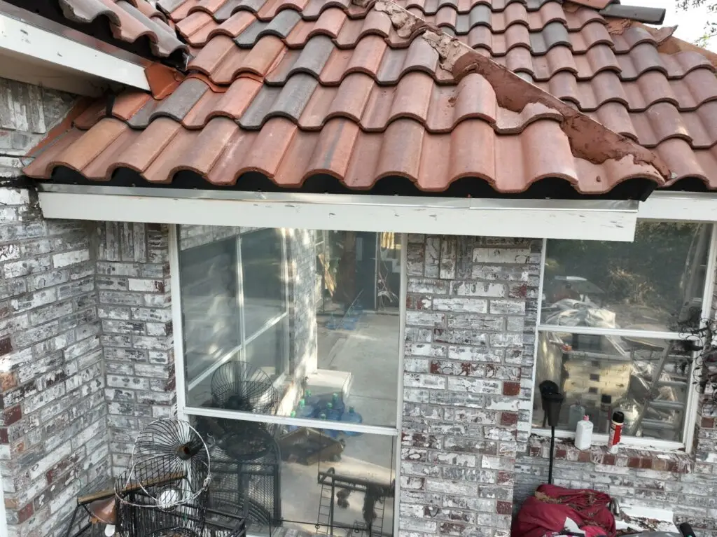 Roof tiles being reset after edge repair by Shepherd Tile Roofing