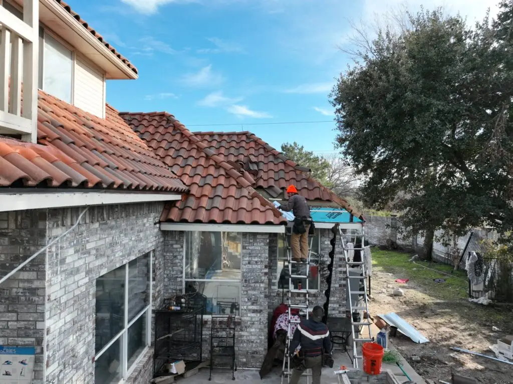 Roof tiles being reset after edge repair by Shepherd Tile Roofing