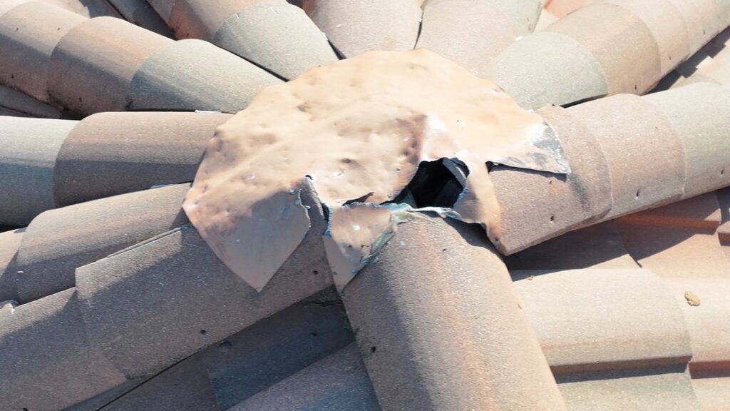 Squirrel damage to lead flashing on clay tile roof