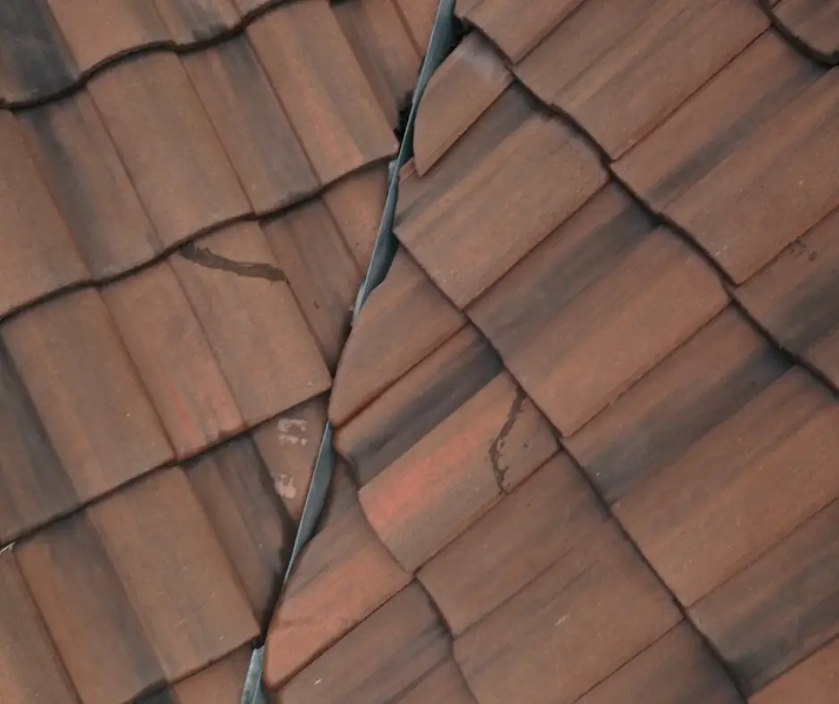 Hairline cracks in roof tiles from North Texas storm impact.