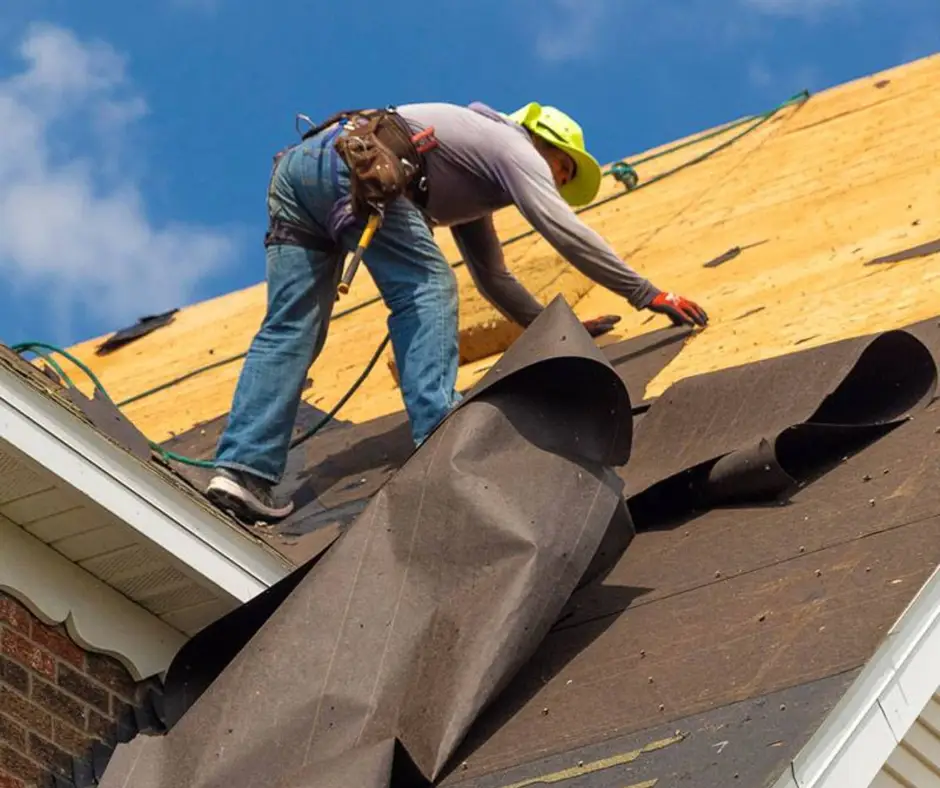 Heat-damaged underlayment beneath clay tiles on a North Texas roof inspection.